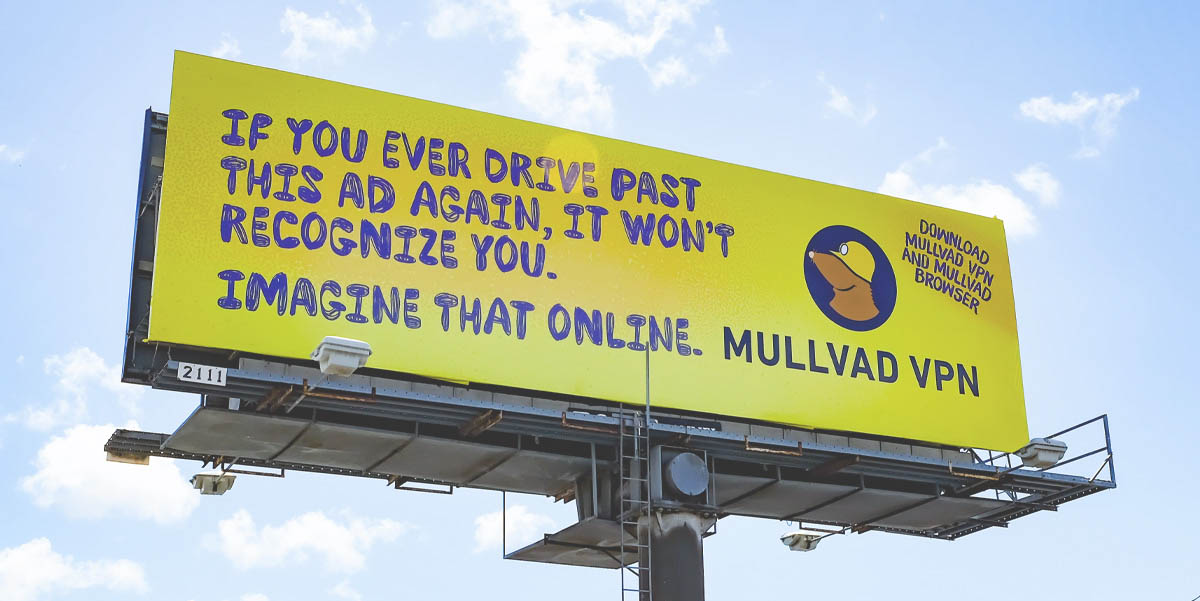 Yellow Mullvad VPN billboard: IF YOU EVER DRIVE PAST THIS AD AGAIN, IT WON'T RECOGNIZE YOU. IMAGINE THAT ONLINE. DOWNLOAD MULLVAD VPN AND BROWSER.